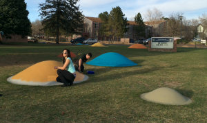 Engineering students put the final touches on a solar system courtyard at Jack Swigert Aerospace Academy.