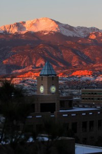 Pikes Peak glows pink and orange during a winter sunrise. Photo by Tom Kimmell